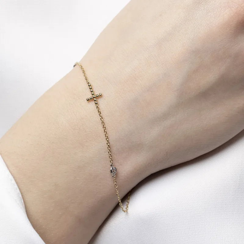 Yellow gold bracelet with cross and cubic zirconia