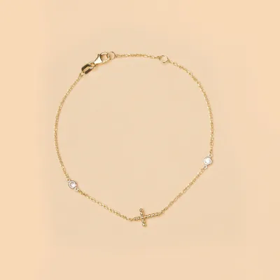 Yellow gold bracelet with cross and cubic zirconia