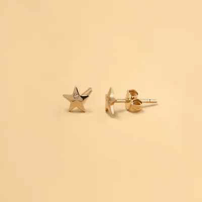 Yellow gold star-shaped earrings with cubic zirconia
