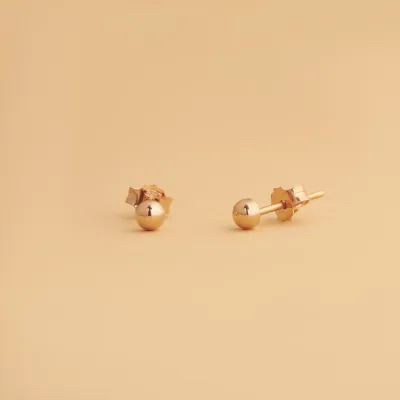 Rose gold stud earrings  in the shape of a sphere